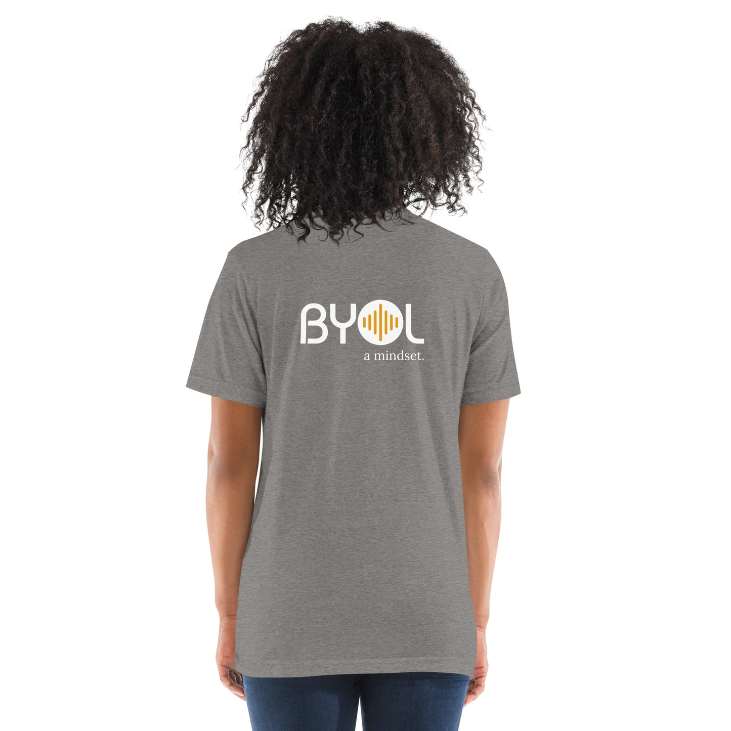 Back view of a woman wearing a grey triblend BYOL mindset t-shirt with color options in black, red, pink, gray, and yellow, available in sizes S to 3XL.