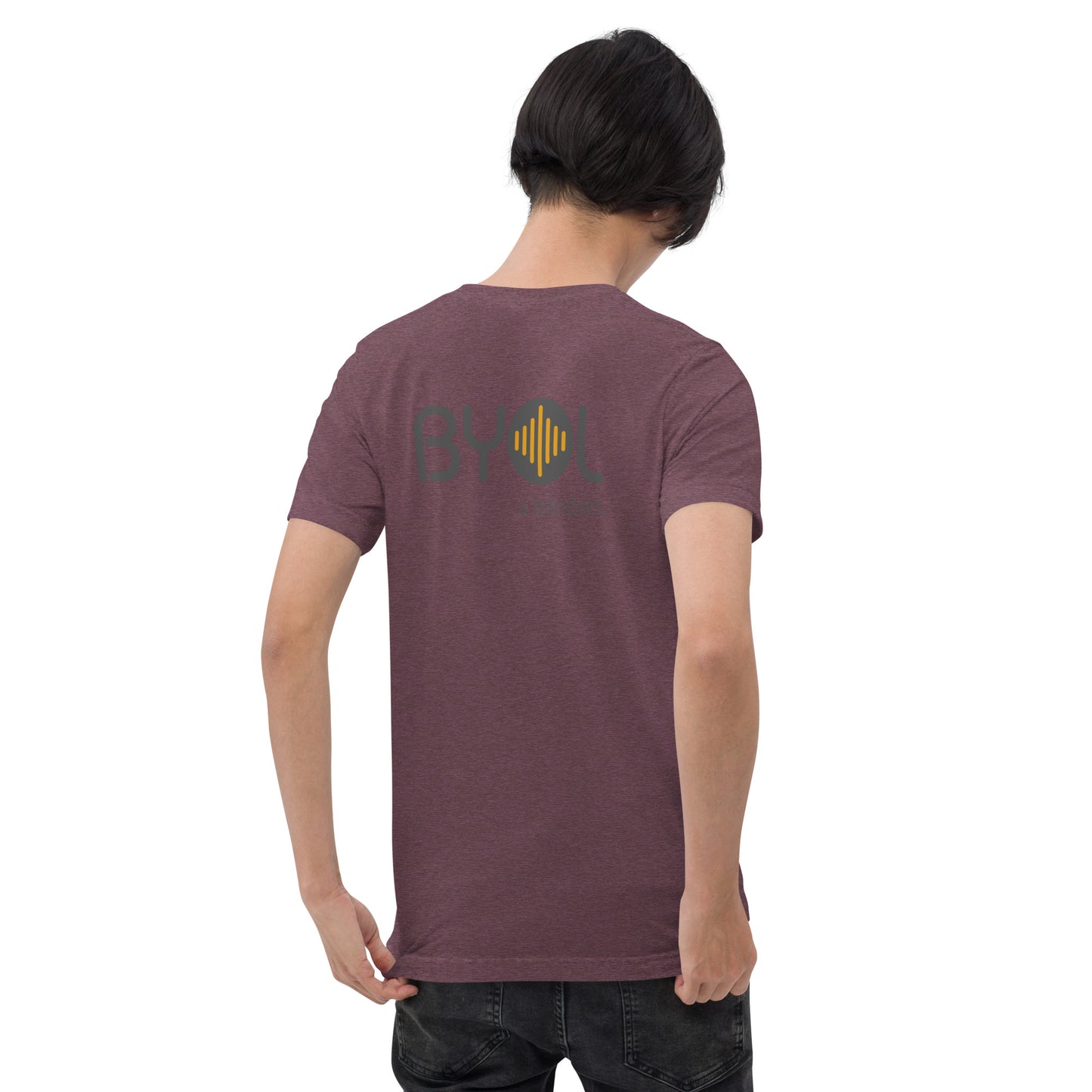 A young man with short black hair wearing a purple tri-blend "BYOL: a mindset" T-shirt, viewed from the back. The T-shirt features the "BYOL" logo in black and yellow on the back and is available in multiple colors (black, red, gray, pink, gold, plus more) and sizes (S-3XL). The "be you out loud" logo is displayed at the top.