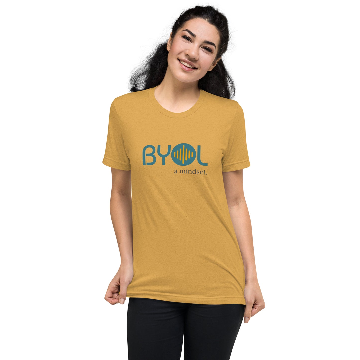 Woman wearing a mustard triblend BYOL mindset t-shirt with color options in black, red, pink, gray, and yellow, available in sizes S to 3XL.