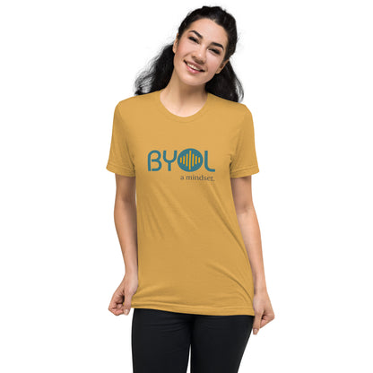 Woman wearing a mustard triblend BYOL mindset t-shirt with color options in black, red, pink, gray, and yellow, available in sizes S to 3XL.