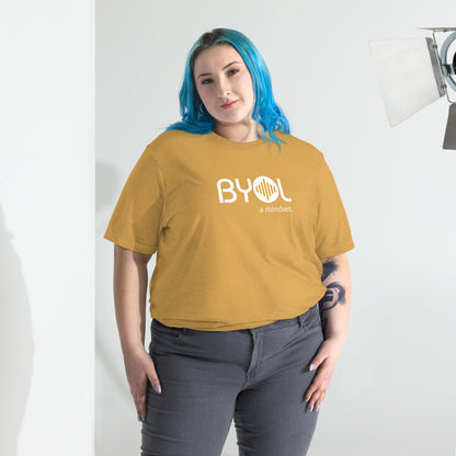 Woman wearing a loose fit BYOL mindset t-shirt in mustard triblend with color options in black, red, pink, gray, and yellow, available in sizes S to 3XL.