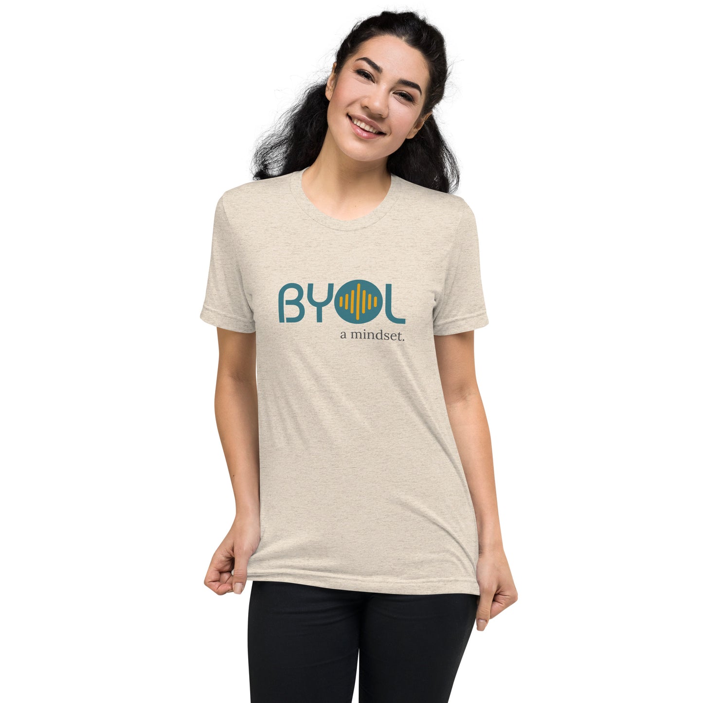 Woman wearing a oatmeal triblend BYOL mindset t-shirt with color options in black, red, pink, gray, and yellow, available in sizes S to 3XL.