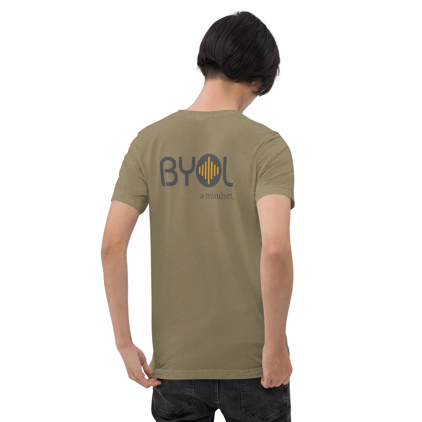 A young man with short black hair wearing a olive green tri-blend "BYOL: a mindset" T-shirt, viewed from the back. The T-shirt features the "BYOL" logo in black and yellow on the back and is available in multiple colors (black, red, gray, pink, gold, plus more) and sizes (S-3XL). The "be you out loud" logo is displayed at the top.