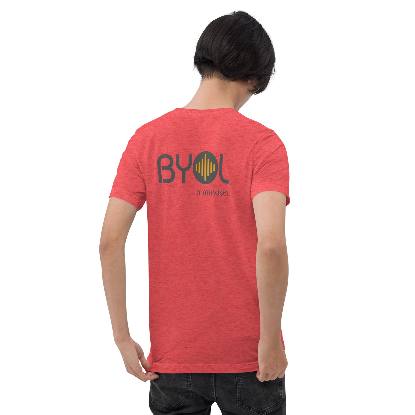 A young man with short black hair wearing a red tri-blend "BYOL: a mindset" T-shirt, viewed from the back. The T-shirt features the "BYOL" logo in black and yellow on the back and is available in multiple colors (black, red, gray, pink, gold, plus more) and sizes (S-3XL). The "be you out loud" logo is displayed at the top.