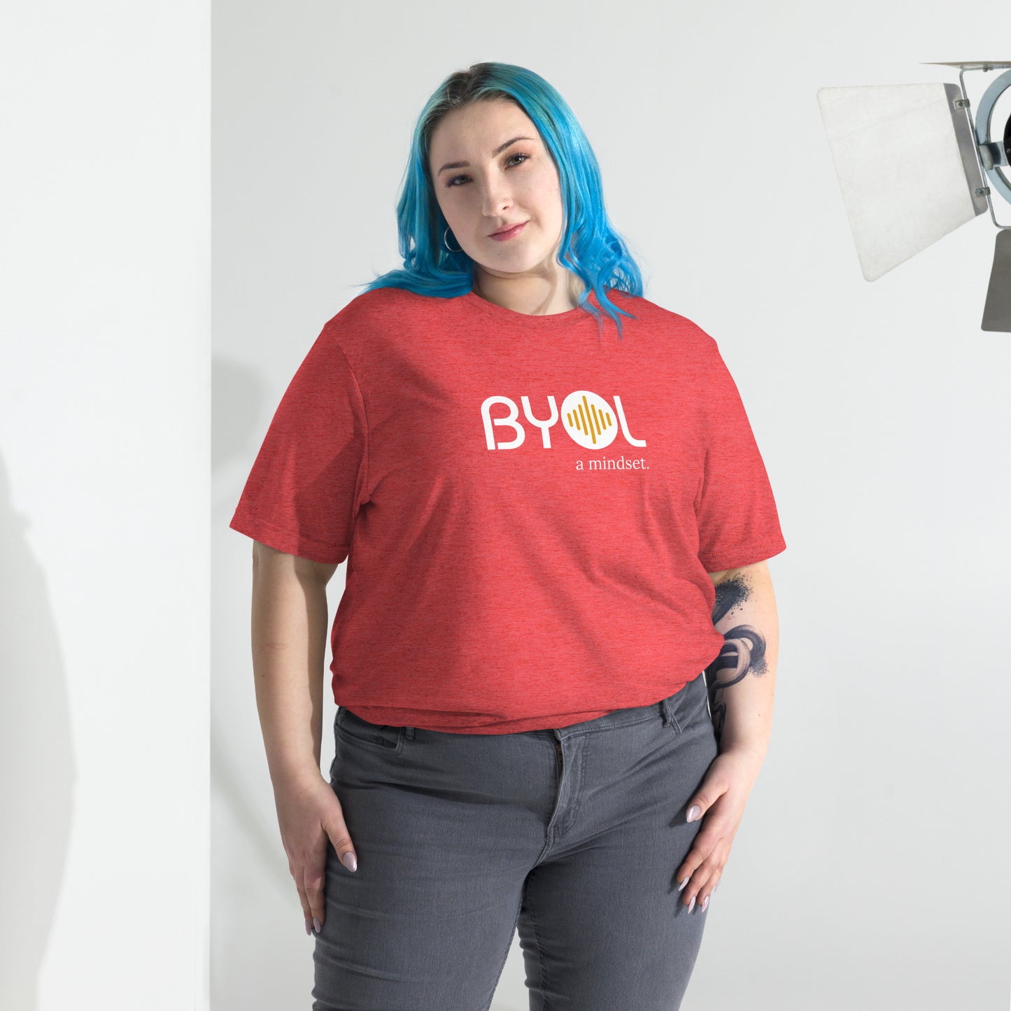 Woman wearing a loose fit BYOL mindset t-shirt in red triblend with color options in black, red, pink, gray, and yellow, available in sizes S to 3XL.