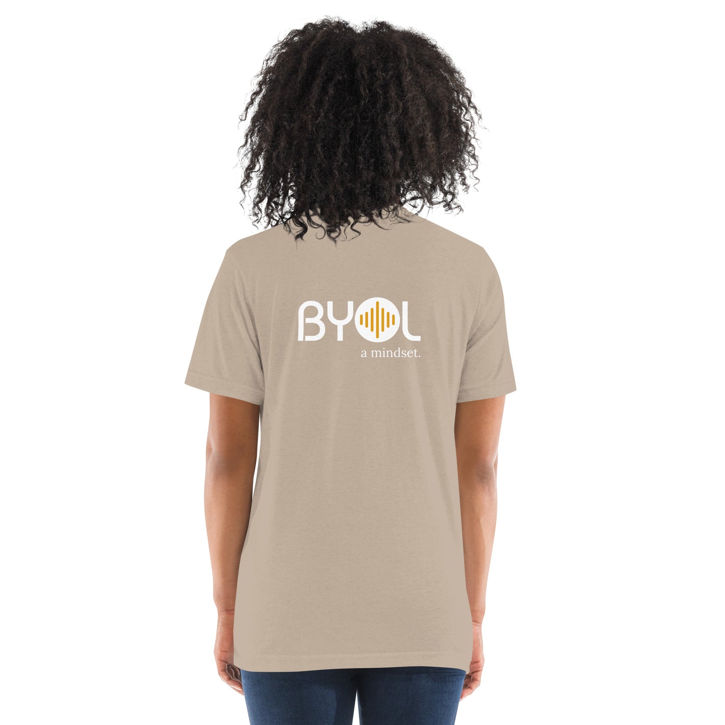 Back view of a woman wearing a tan triblend BYOL mindset t-shirt with color options in black, red, pink, gray, and yellow, available in sizes S to 3XL.