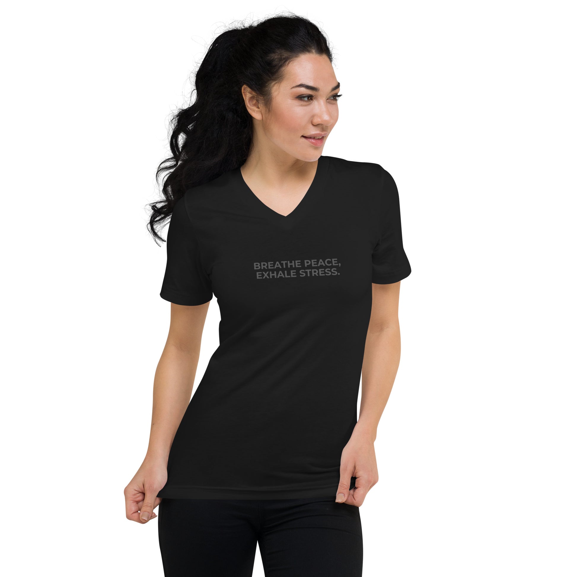 Woman in a black V-neck tee with "Breathe Peace, Exhale Stress" text.