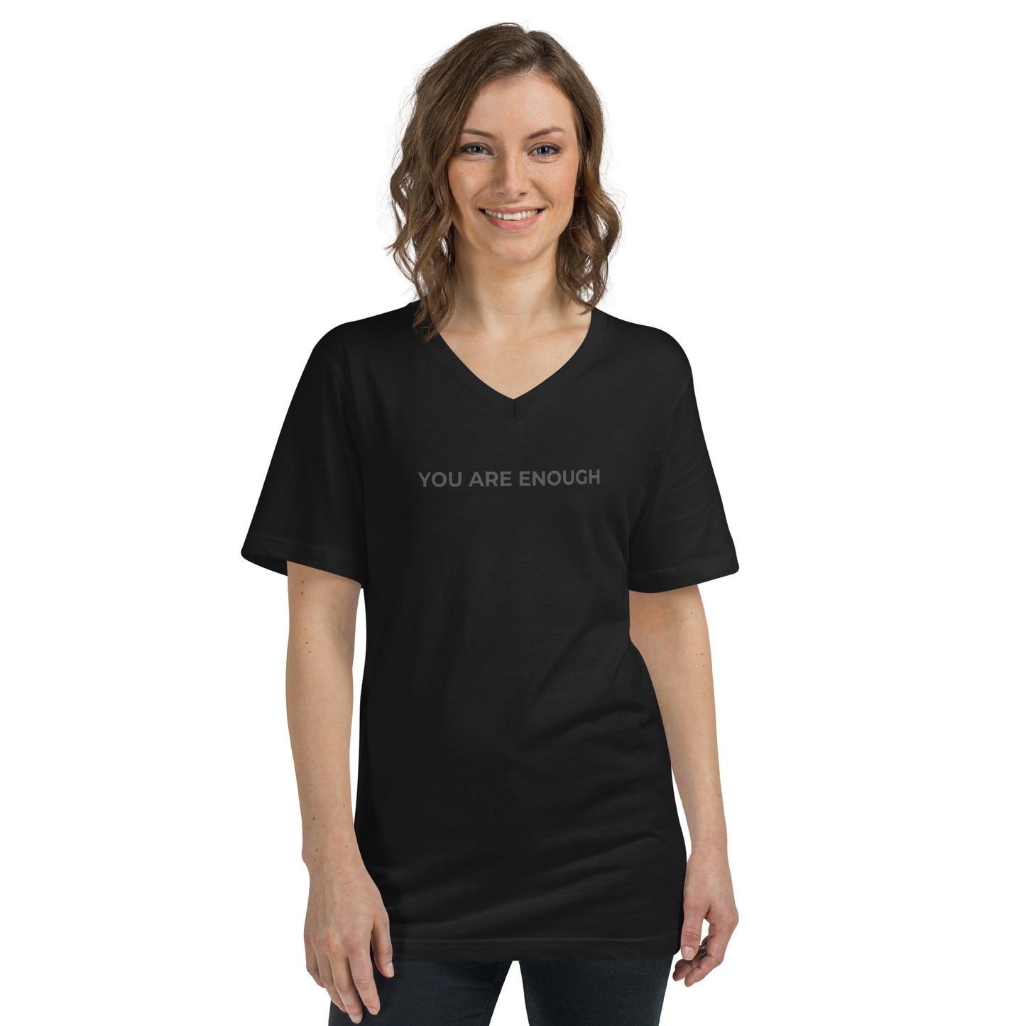 Smiling woman wearing a black V-neck tee with "You Are Enough" text.