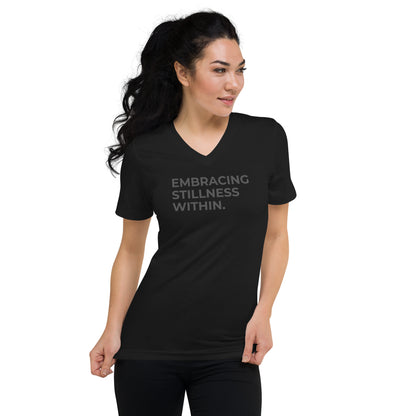 Woman in a black V-neck tee with "Embracing Stillness Within" text.