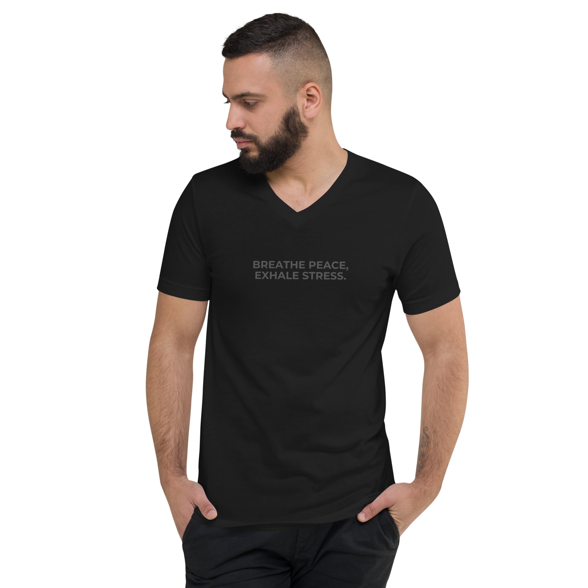 Man with a beard wearing a black v-neck tee with the text "Breathe Peace, Exhale Stress".