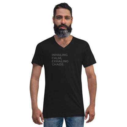 Man with a beard wearing a black v-neck tee with the text "Inhaling Calm, Exhaling Chaos".