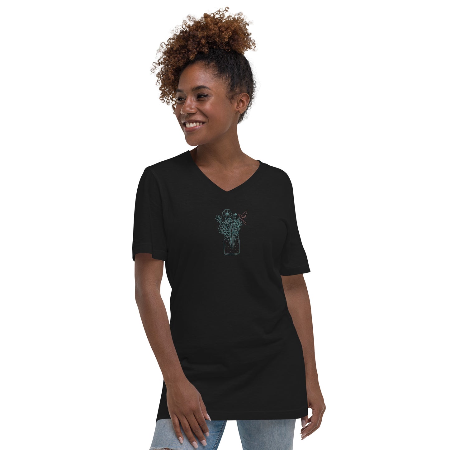 Woman wearing a black V-neck tee with a floral jar design, showcasing subtle elegance and authenticity.