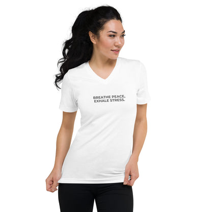 Woman in a white V-neck tee with "Breathe Peace, Exhale Stress" text.