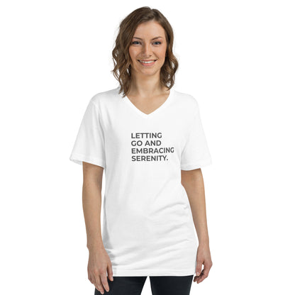 Smiling woman in a white V-neck tee with "Letting Go and Embracing Serenity" text.