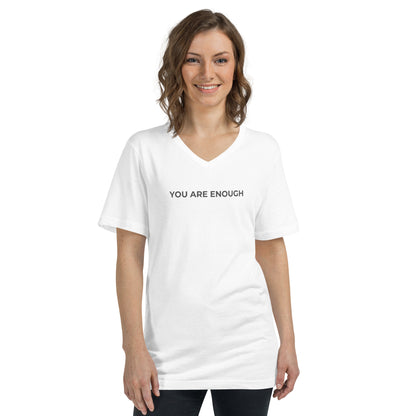 Smiling woman wearing a white V-neck tee with "You Are Enough" text.