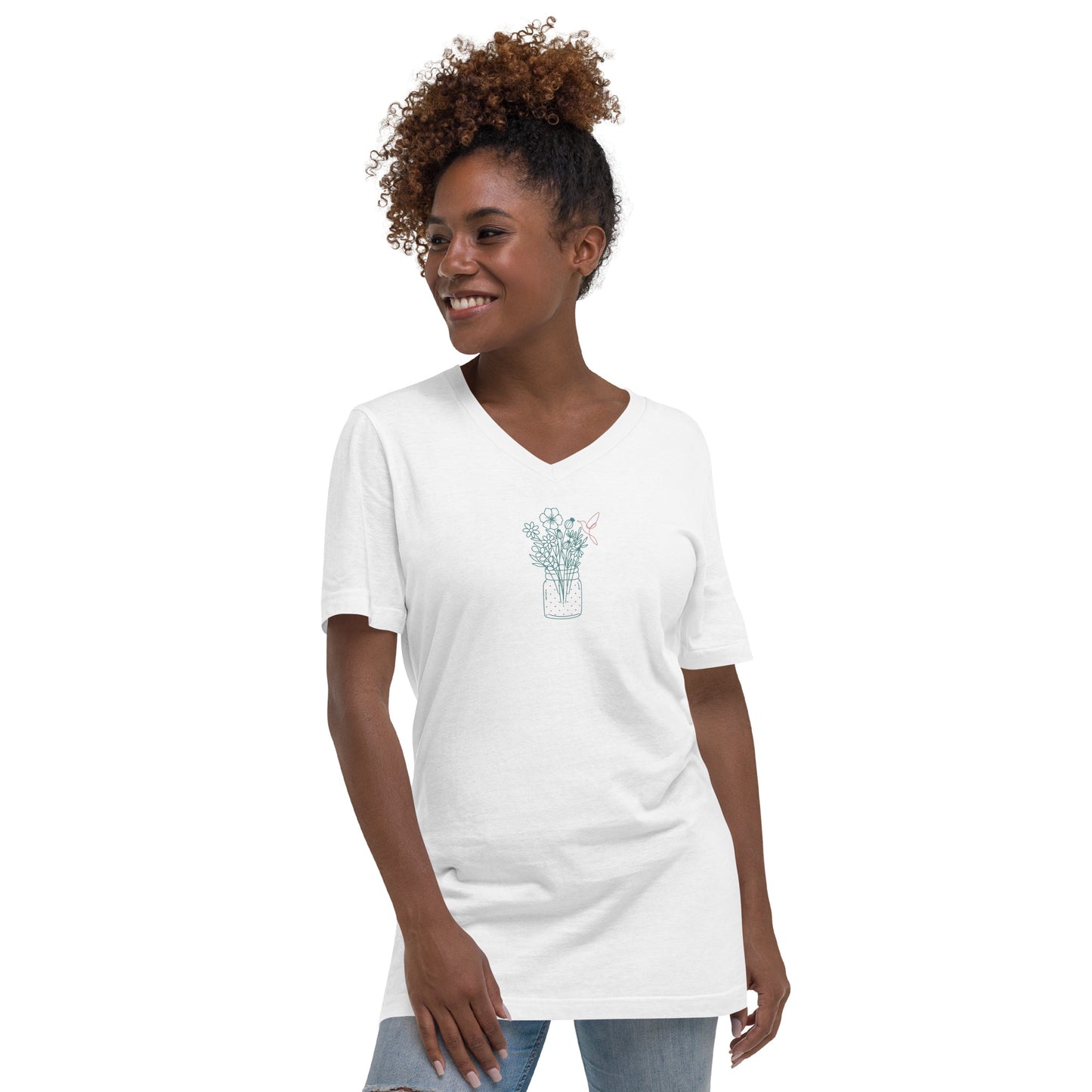 Woman wearing a white V-neck tee with a floral jar design, showcasing subtle elegance and authenticity.