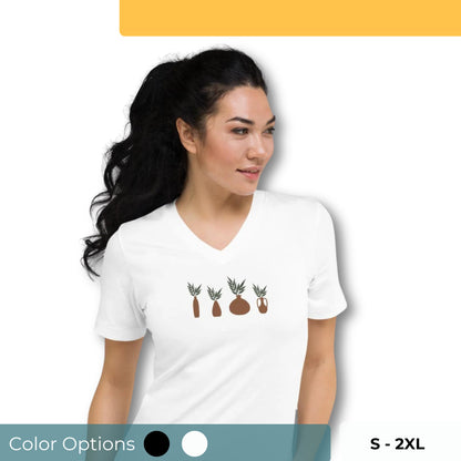 Woman wearing a white V-neck tee with a nature elements design, showcasing authenticity and love for nature. Also showing that they have color options of black and white and come in the sizes between s-2xl