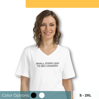 Smiling woman wearing a white V-neck tee with "Small Steps Lead to Big Changes" text, available in black and white, sizes S-2XL.