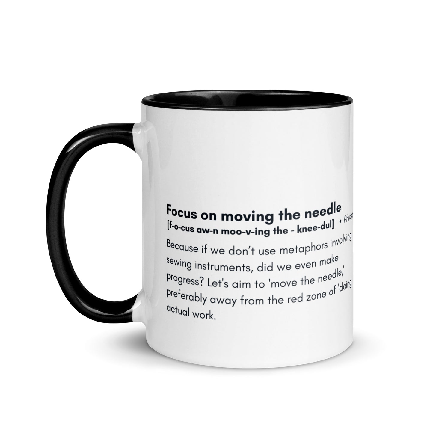 Ceramic white cup with back inside and handle with the words, "focus on moving the needle" followed by a humorous definition 