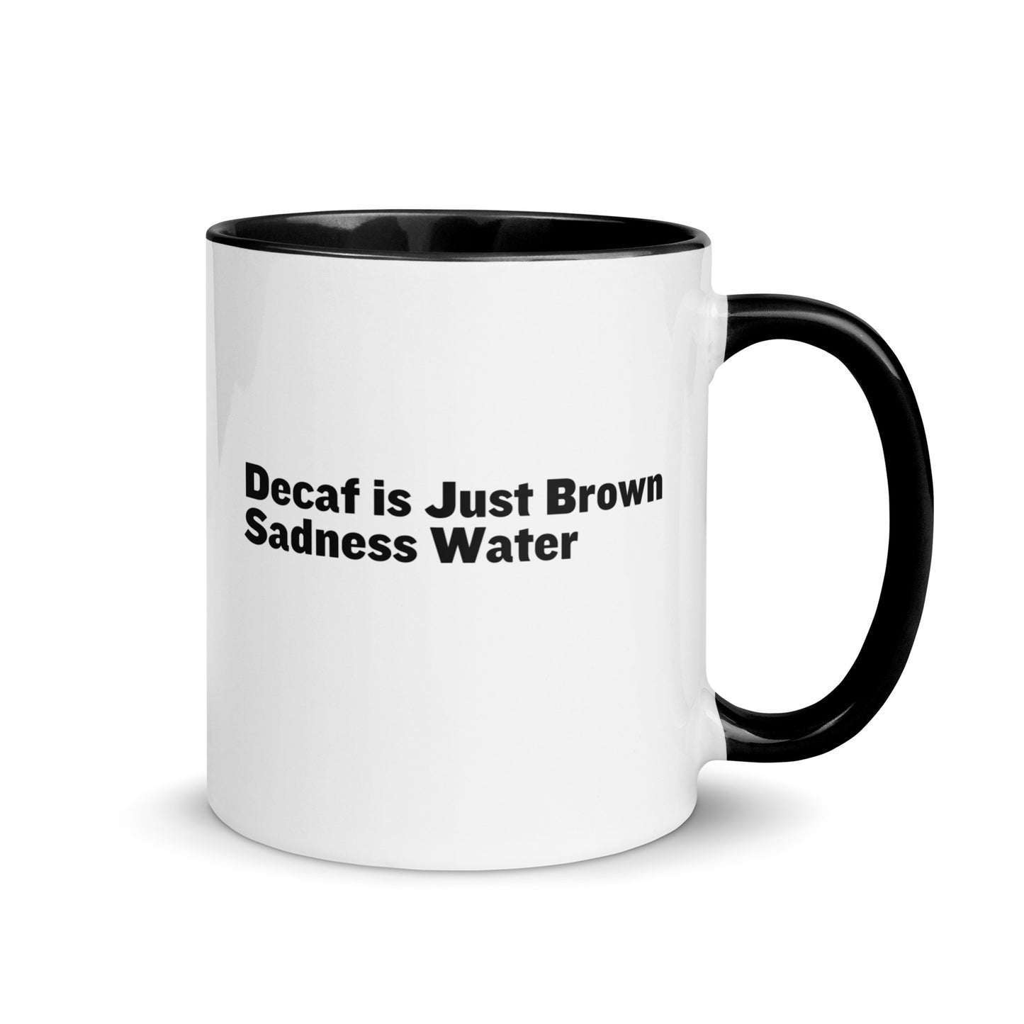 White ceramic mug with a black inside and handle with the words, "Decaf is just Brown Sadness water"