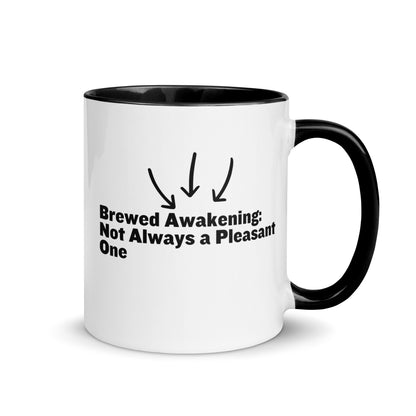 White ceramic mug with black on the inside and on the handle with the words, "Brewed awakening: Not always a pleasant one