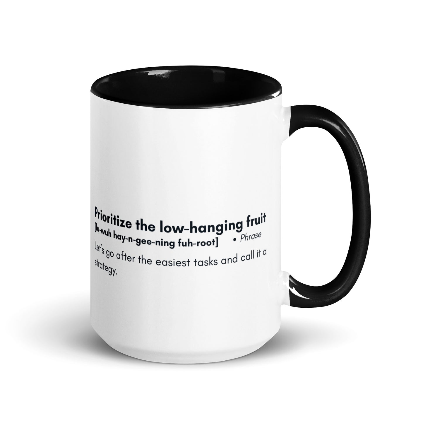 White ceramic mug with black inside and handle with words "Prioritize the low hanging fruit" followed by a humorous definition. 