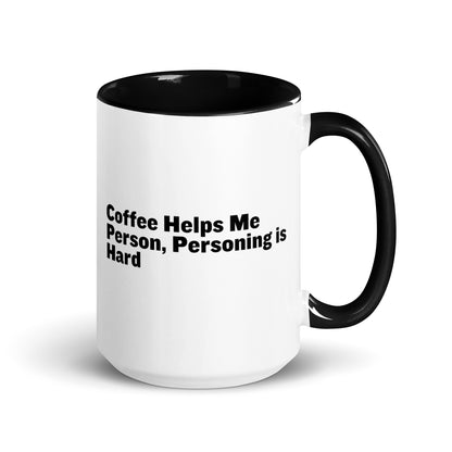 White ceramic mug with black inside and on the handle with the words, "Coffee helps me person, personing is hard"