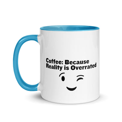 White ceramic mug with light blue on the inside and on the handle with the words, "Coffee: Because reality is overrated"