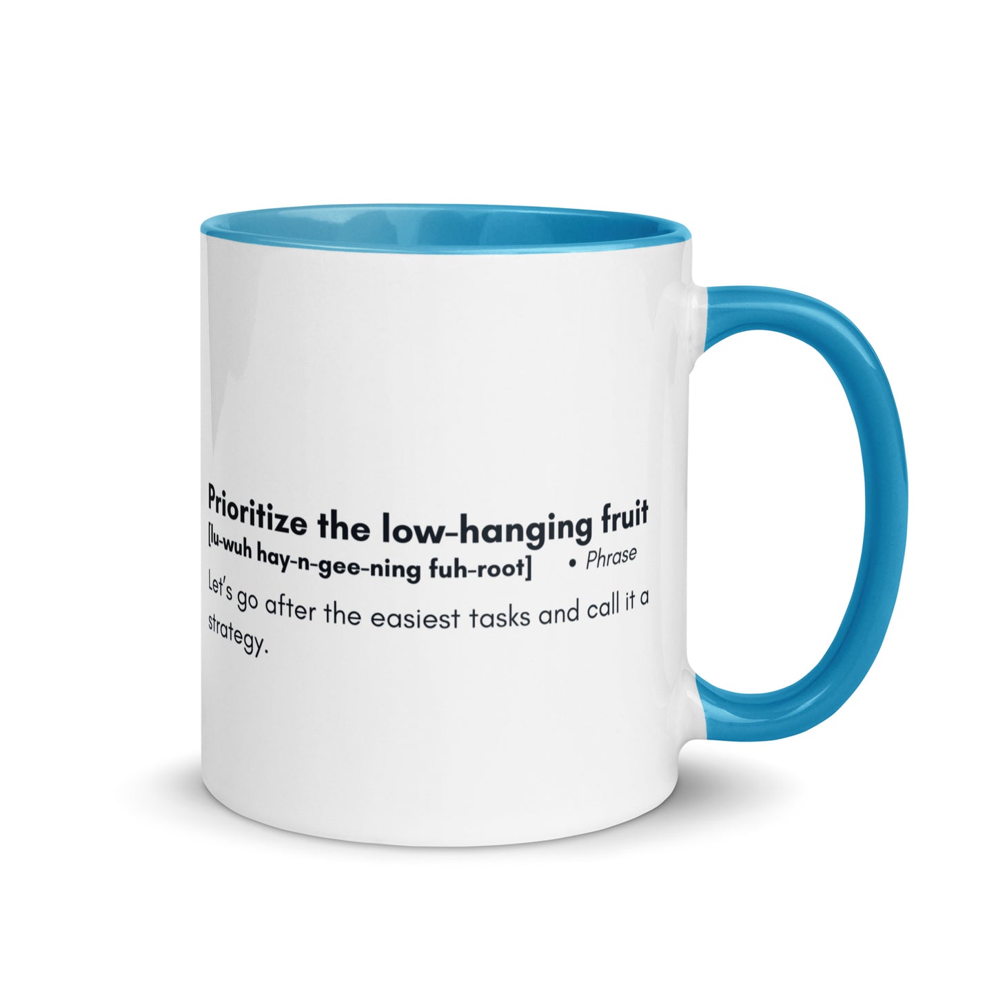 White ceramic mug with light blue inside and handle with words "Prioritize the low hanging fruit" followed by a humorous definition. 