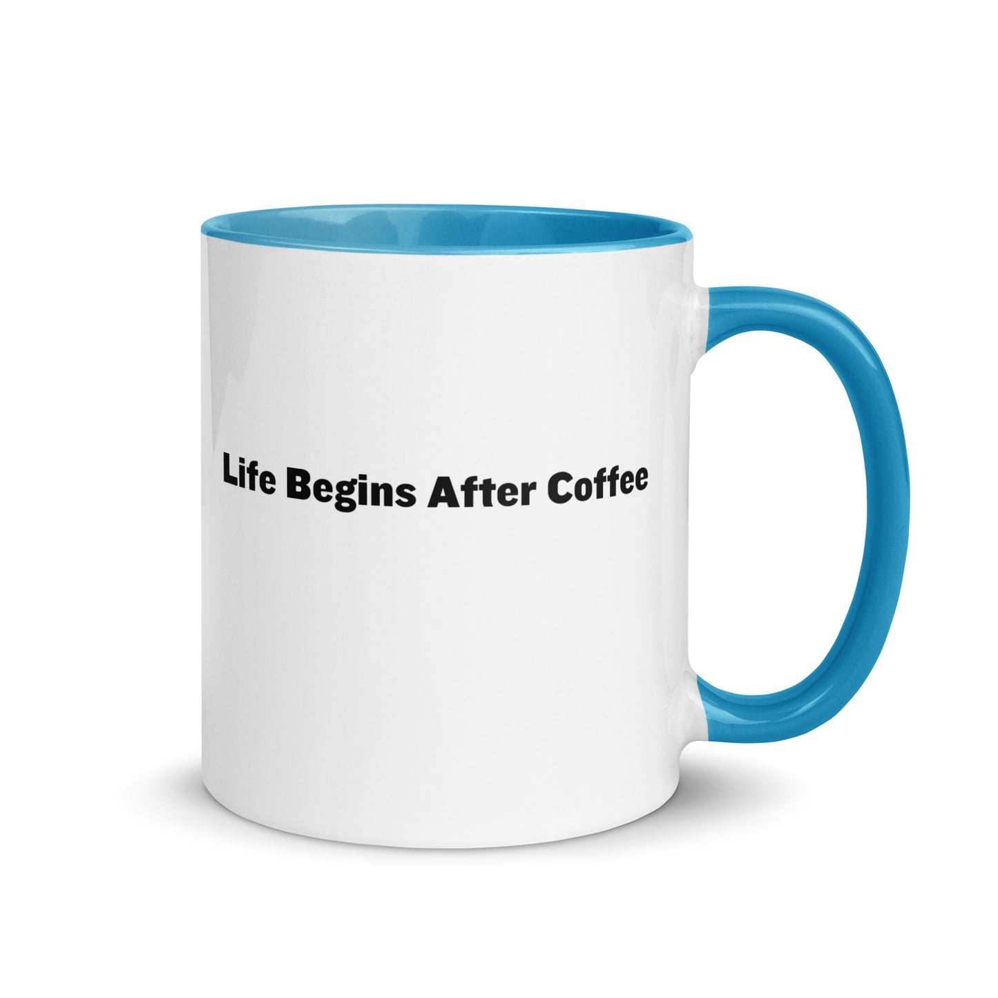 White ceramic mugs with light blue inside and handle with the words, "Life begins after coffee"