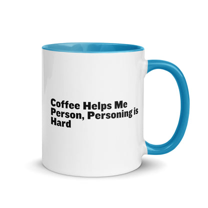 White ceramic mug with light blue inside and on the handle with the words, "Coffee helps me person, personing is hard"