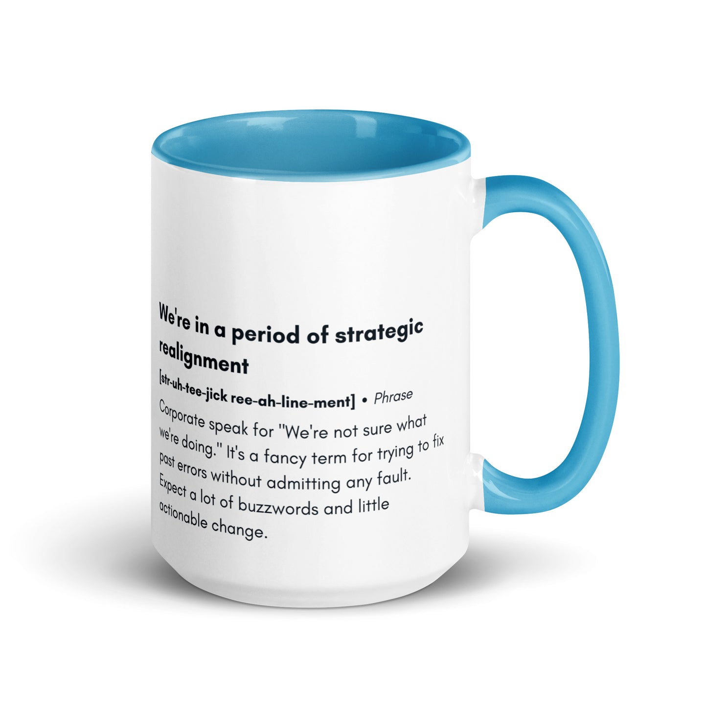 ceramic white mug with light blue inside and handle with the words "we're in a period of strategic realignment" with a humorous definition. 