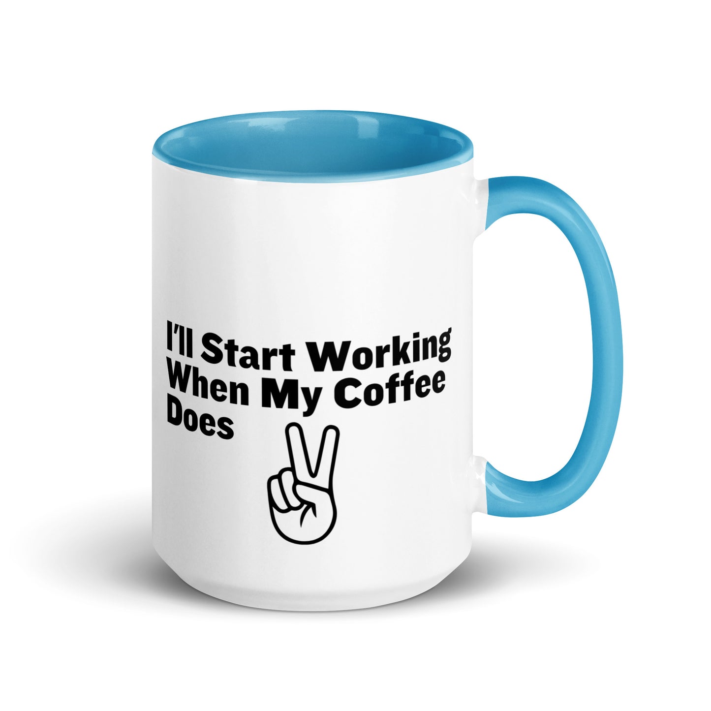 White ceramic mug with a light blue inside and handle with the words, "I'll start working when my coffee does"