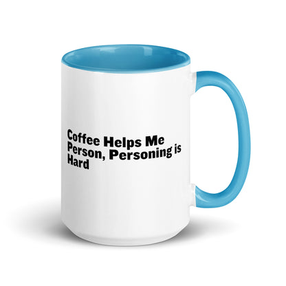 White ceramic mug with light blue inside and on the handle with the words, "Coffee helps me person, personing is hard"