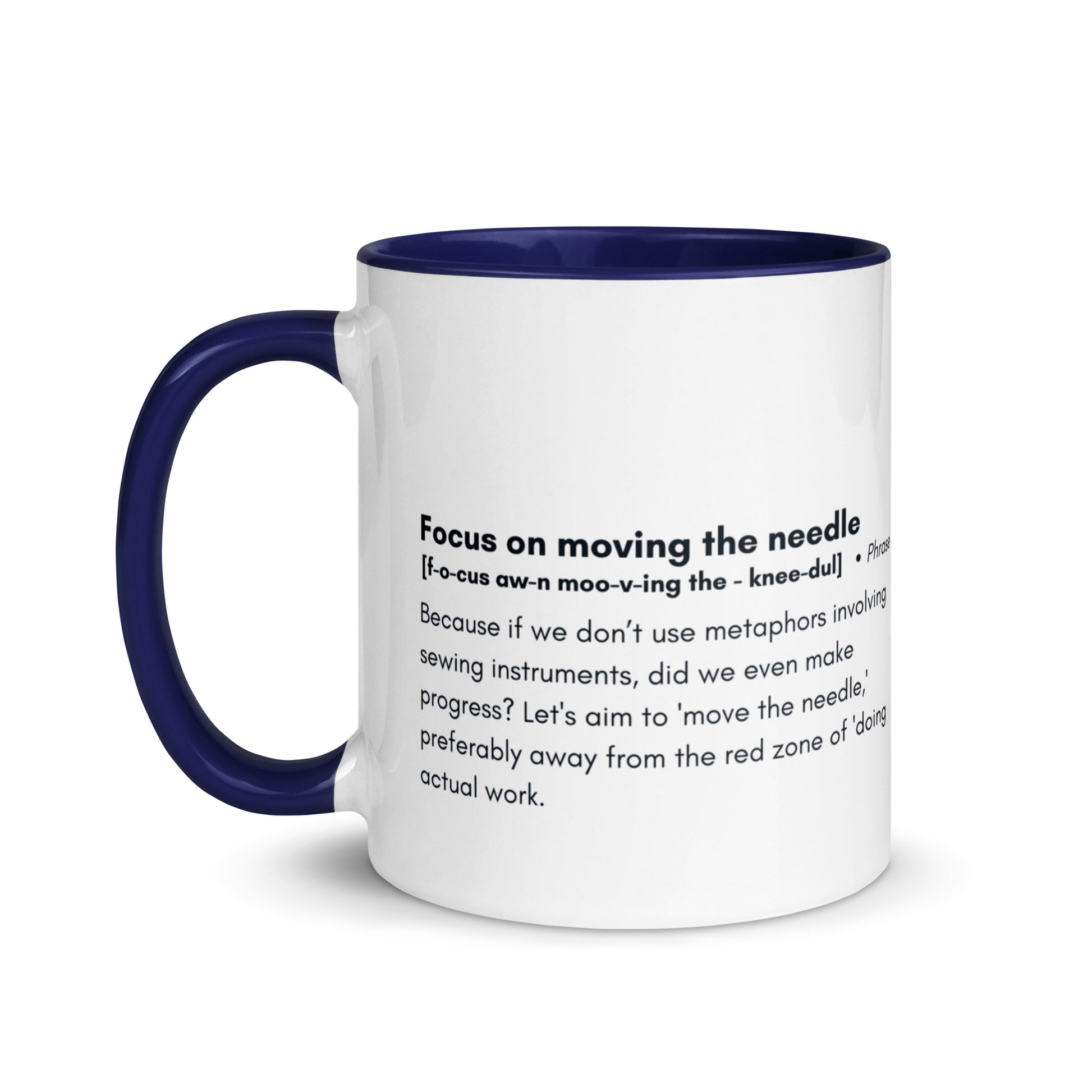 Ceramic white cup with blue inside and handle with the words, "focus on moving the needle" followed by a humorous definition 