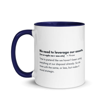 White ceramic mug with blue inside and handle with the words, "We need to leverage our assets" followed by a humorous definition. 