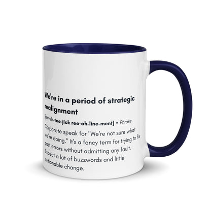 ceramic white mug with blue inside and handle with the words "we're in a period of strategic realignment" with a humorous definition. 