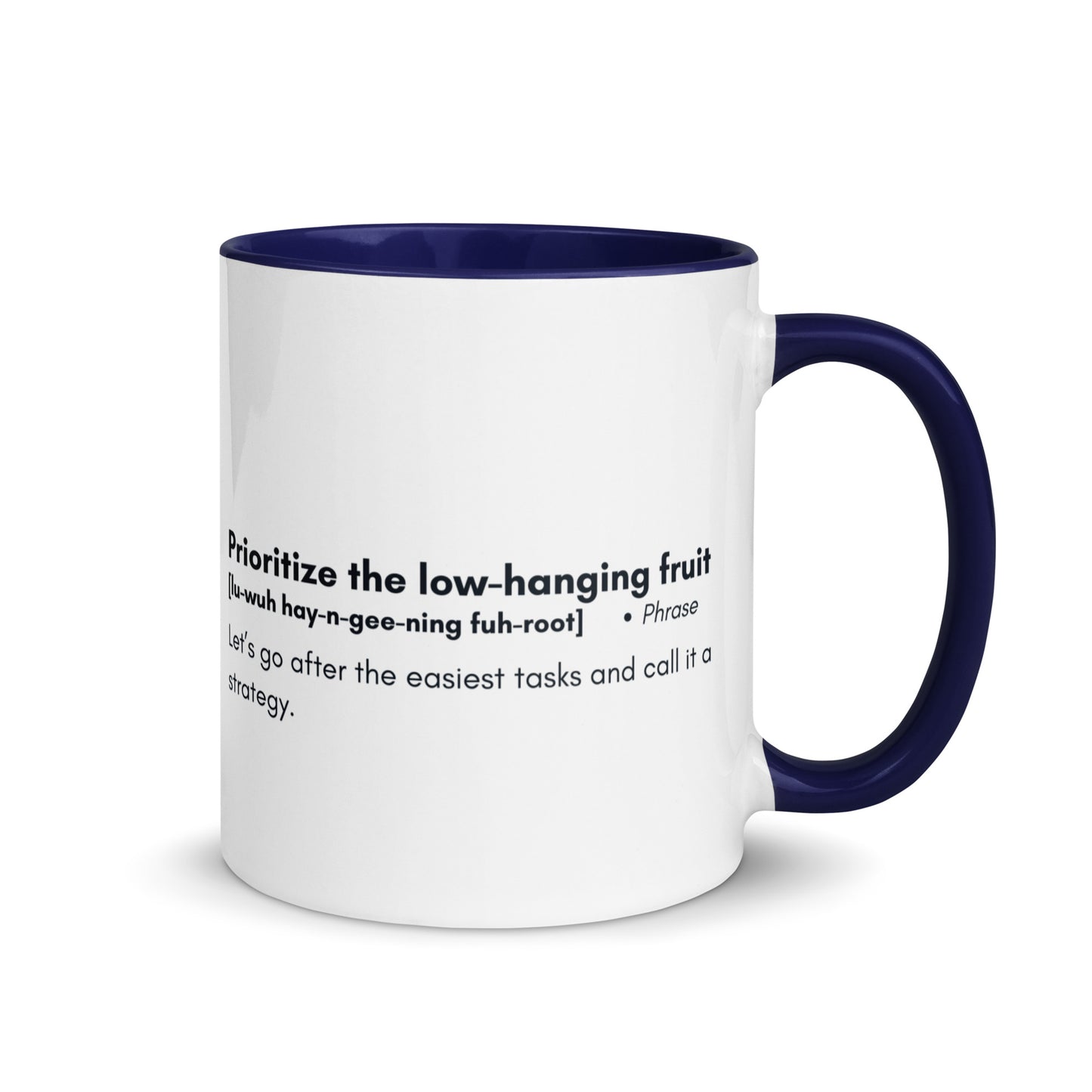 White ceramic mug with blue inside and handle with words "Prioritize the low hanging fruit" followed by a humorous definition. 