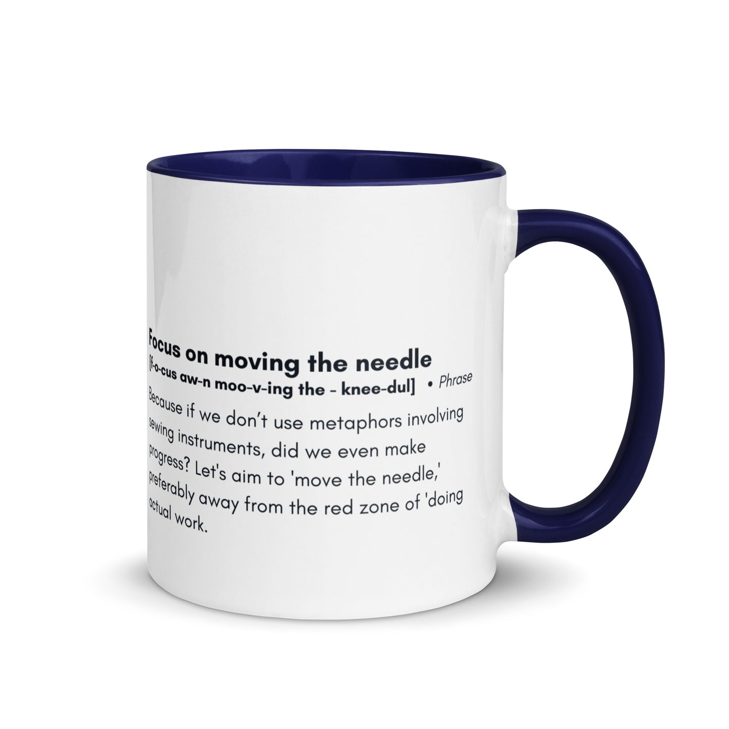 Ceramic white cup with blue inside and handle with the words, "focus on moving the needle" followed by a humorous definition 