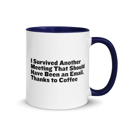 White ceramic mug with blue inside and on the handle with words that say, "I survived another meeting that should have been an email, thanks to coffee"