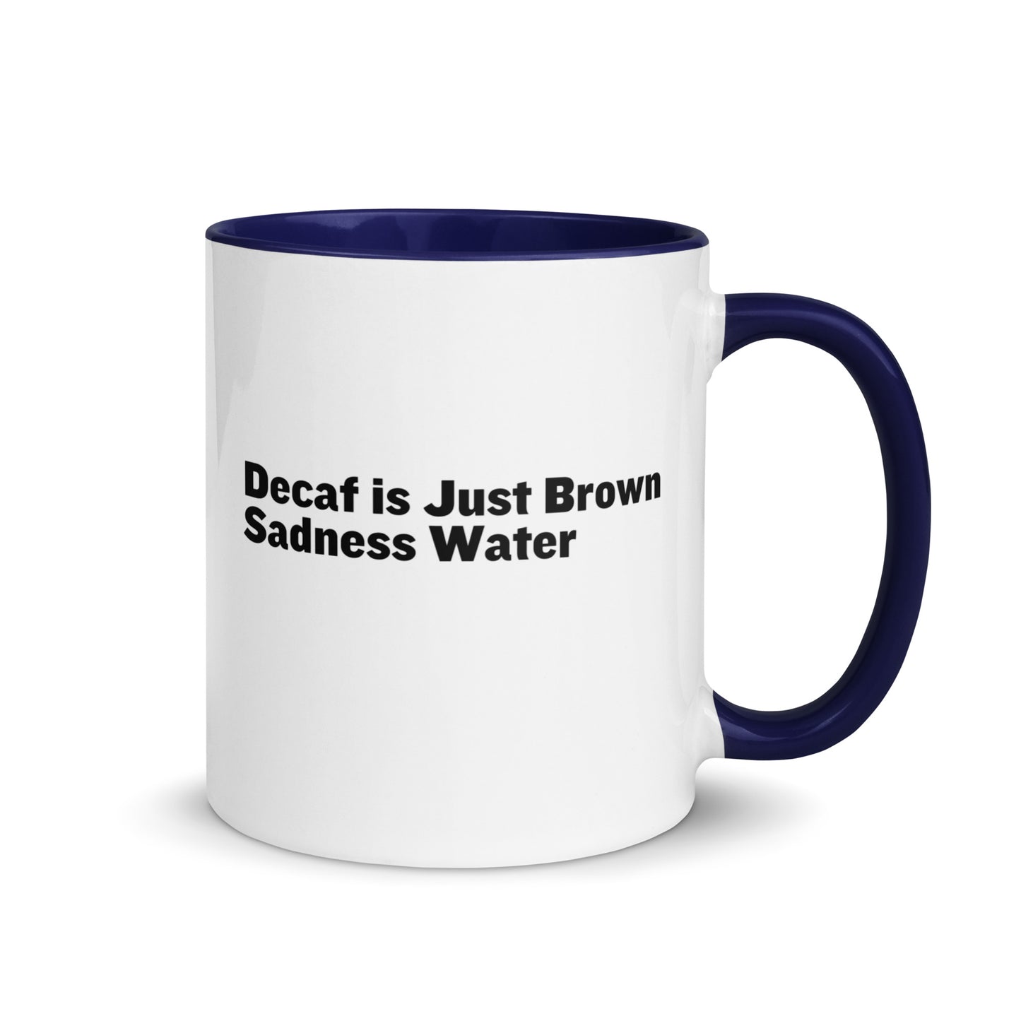 White ceramic mug with a blue inside and handle with the words, "Decaf is just Brown Sadness water"