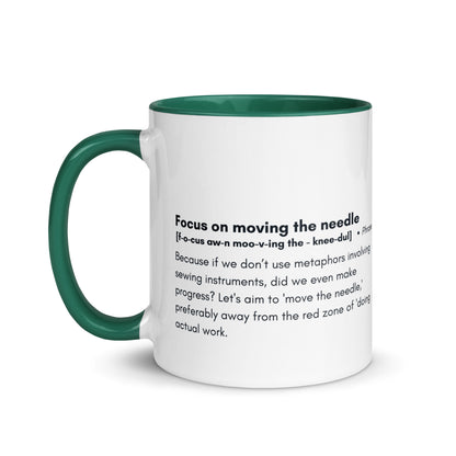 Ceramic white cup with dark green inside and handle with the words, "focus on moving the needle" followed by a humorous definition 