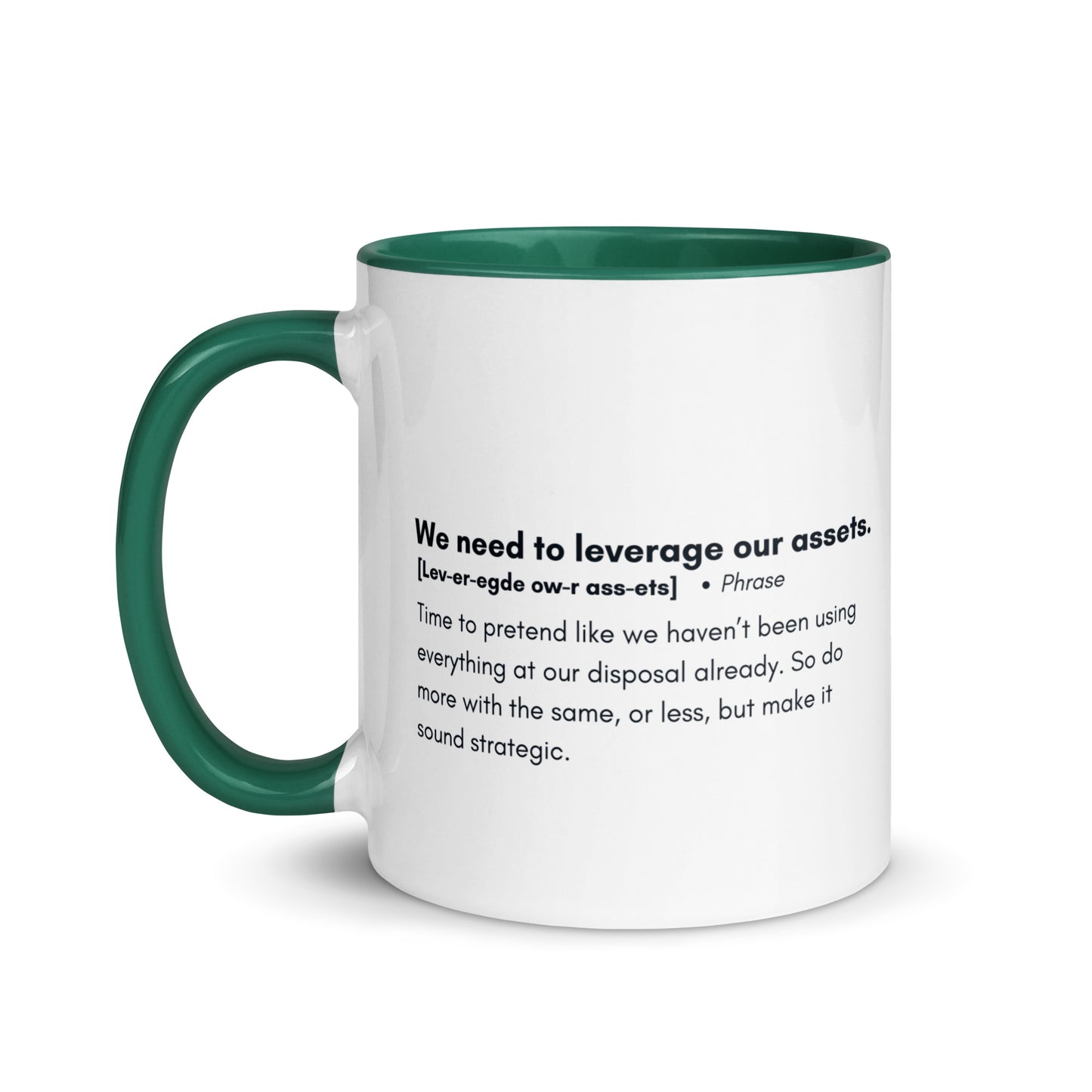 White ceramic mug with green inside and handle with the words, "We need to leverage our assets" followed by a humorous definition.