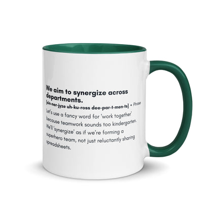 White ceramic mug with dark green inside and handle with word,"We aim to synergize across departments" followed by a humorous definition.