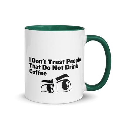 White ceramic mud with green on the inside and on the handle with the words, "I don't trust people that do not drink coffee"