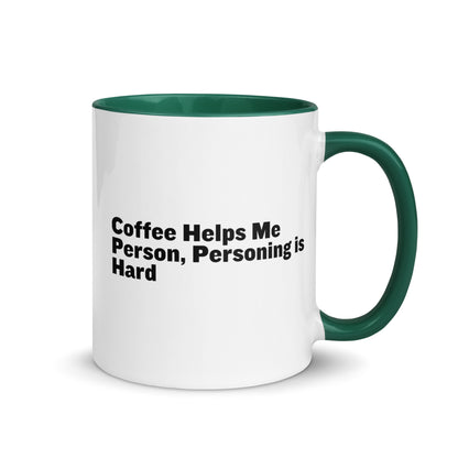 White ceramic mug with green inside and on the handle with the words, "Coffee helps me person, personing is hard"