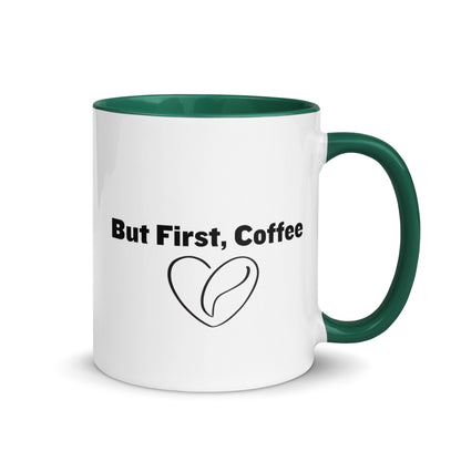 White ceramic mug with green on the inside and on the handle with words that say, "But first, coffee"