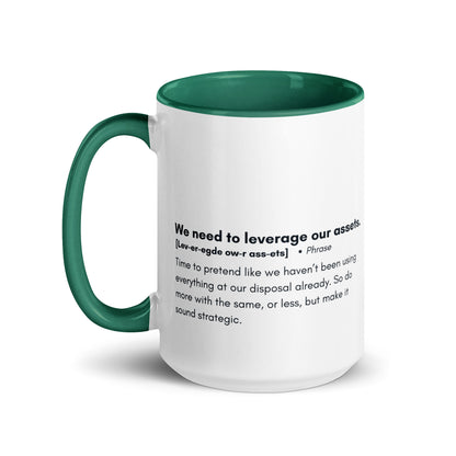 White ceramic mug with green inside and handle with the words, "We need to leverage our assets" followed by a humorous definition.