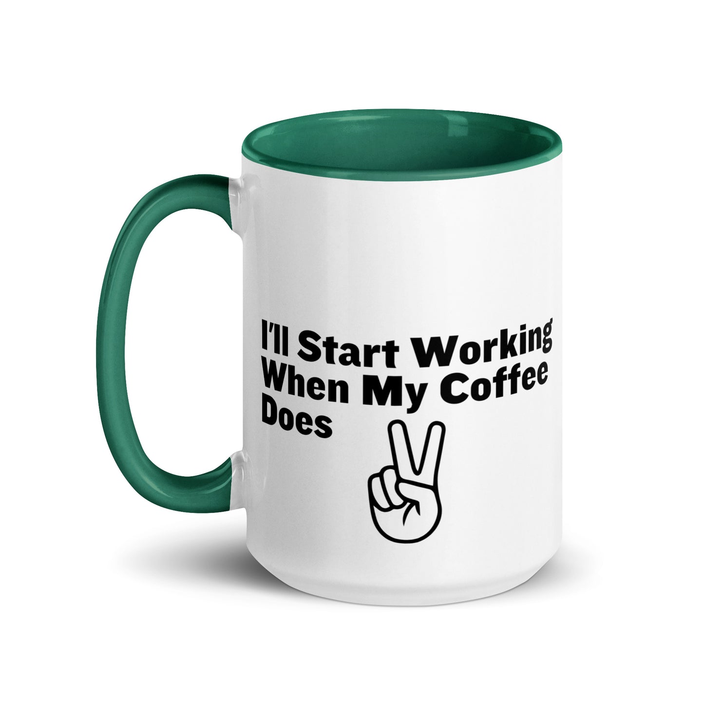 White ceramic mug with a green inside and handle with the words, "I'll start working when my coffee does"