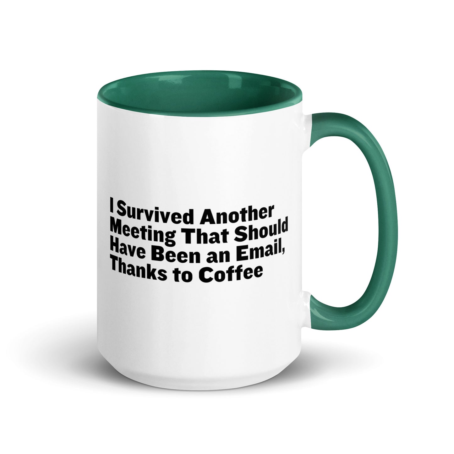 White ceramic mug with green inside and on the handle with words that say, "I survived another meeting that should have been an email, thanks to coffee"